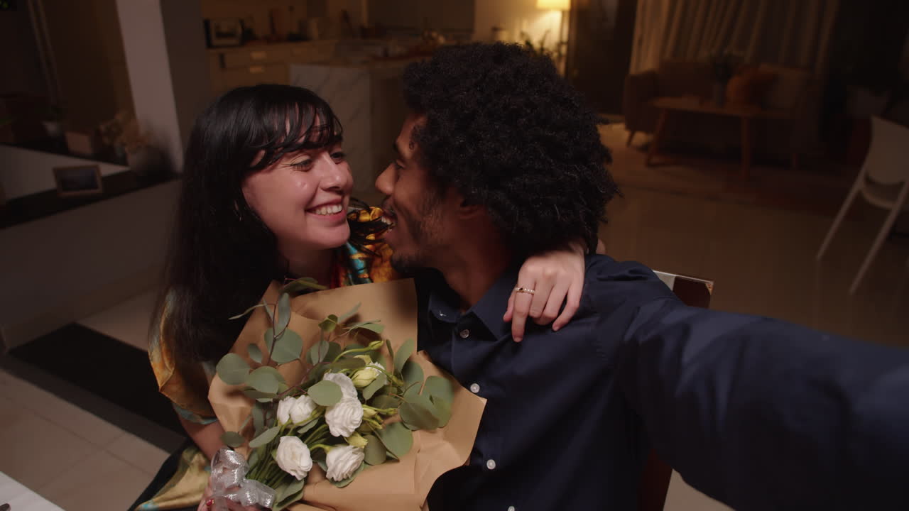 POV of Happy Diverse Man and Woman Doing Selfie with Bouquet of Roses