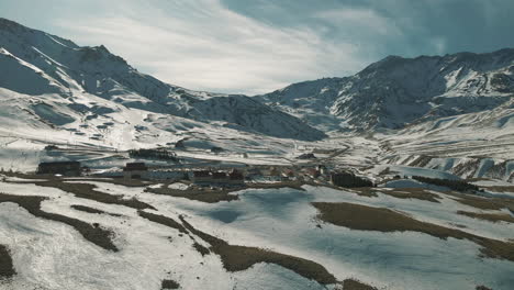 Bird's-eye-view-of-South-America's-largest-and-finest-ski-resort,-Las-Leñas,-showcasing-unparalleled-alpine-beauty-and-winter-sports-excitement