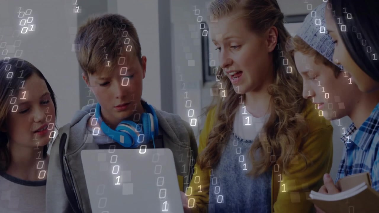 Teen girl tapping laptop showing chart as classmates jotting with binary overlay in school project