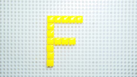 stop motion of the letter f creating one pixel at the time, made with children toys