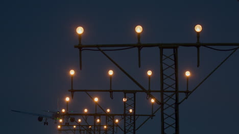 airplane landing at night with approach lights