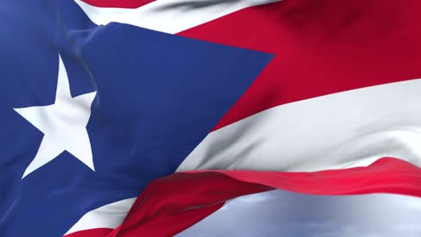 puerto rico flag waving at wind in slow with blue sky, loop