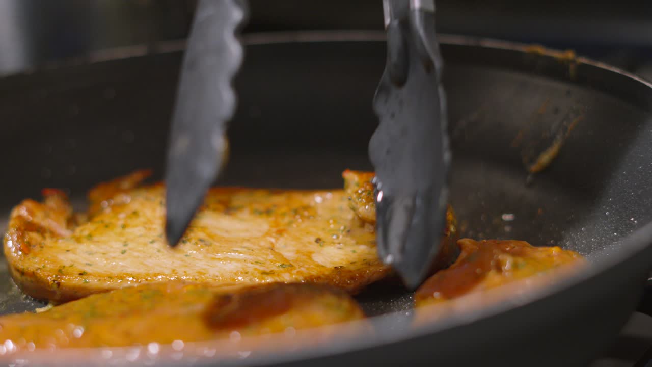 Raw Chinese Chicken Steak Fillets Being Turned in Over in Hot Pan to Cook on Boths Sides. Oriental Style Cuisine. Food Photography Footage 4K.