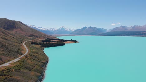 Epic-drone-shot-of-the-famous-turquoise-Pukaki-Lake-with-scenic-view-of-the-Mt