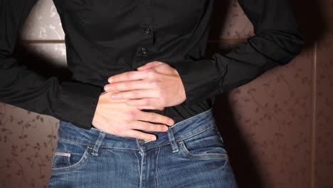 sudden abdominal pain attack, bending with pain, hands on belly