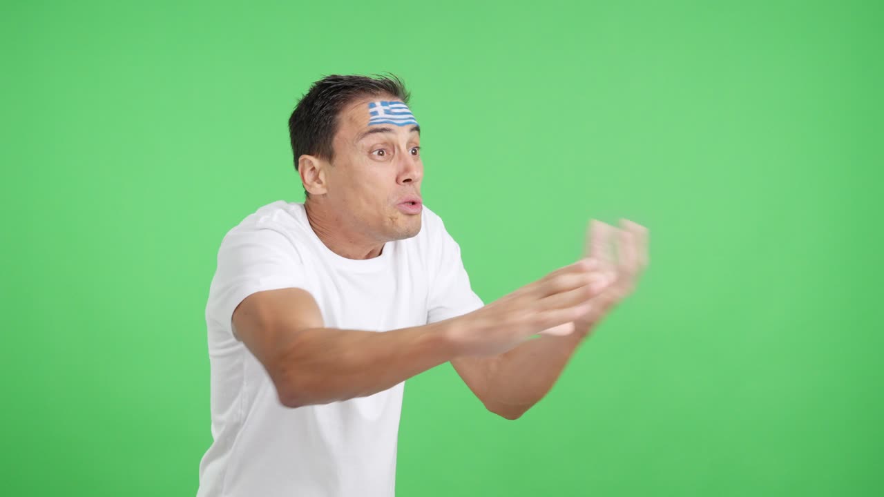 Man cheering for Greece, angry with the decision of referee