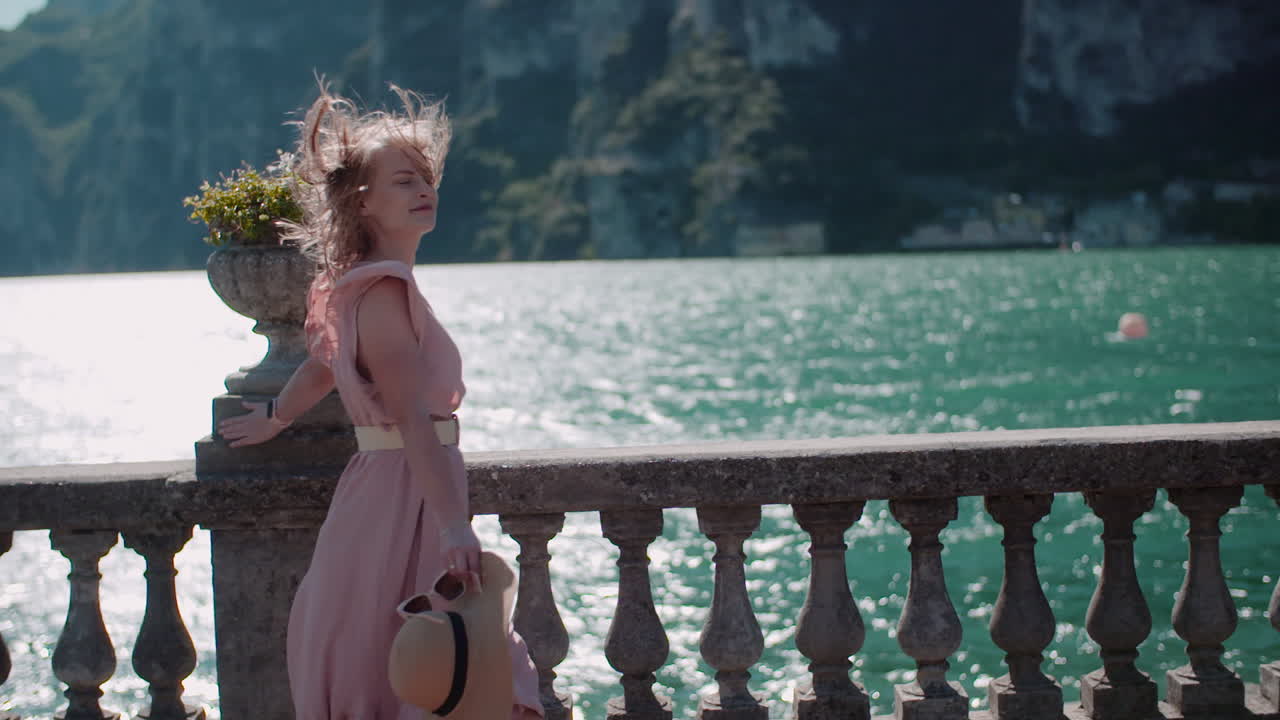 Woman Walking by Seaside Town Pathway