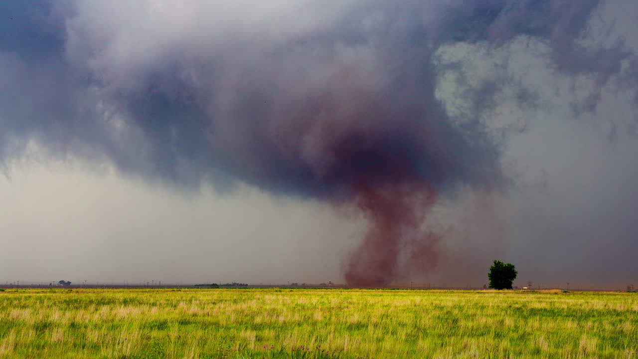 Tornado Touching Ground in Open Plains During Severe Weather Event