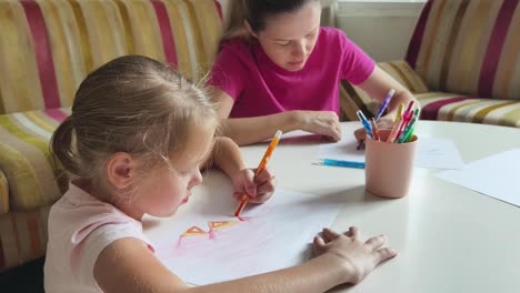 mother and daughter drawing together