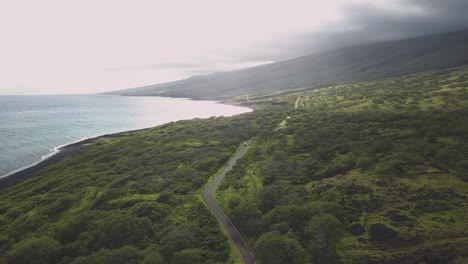 aerial footage of a cmapervan driving along the open coastline