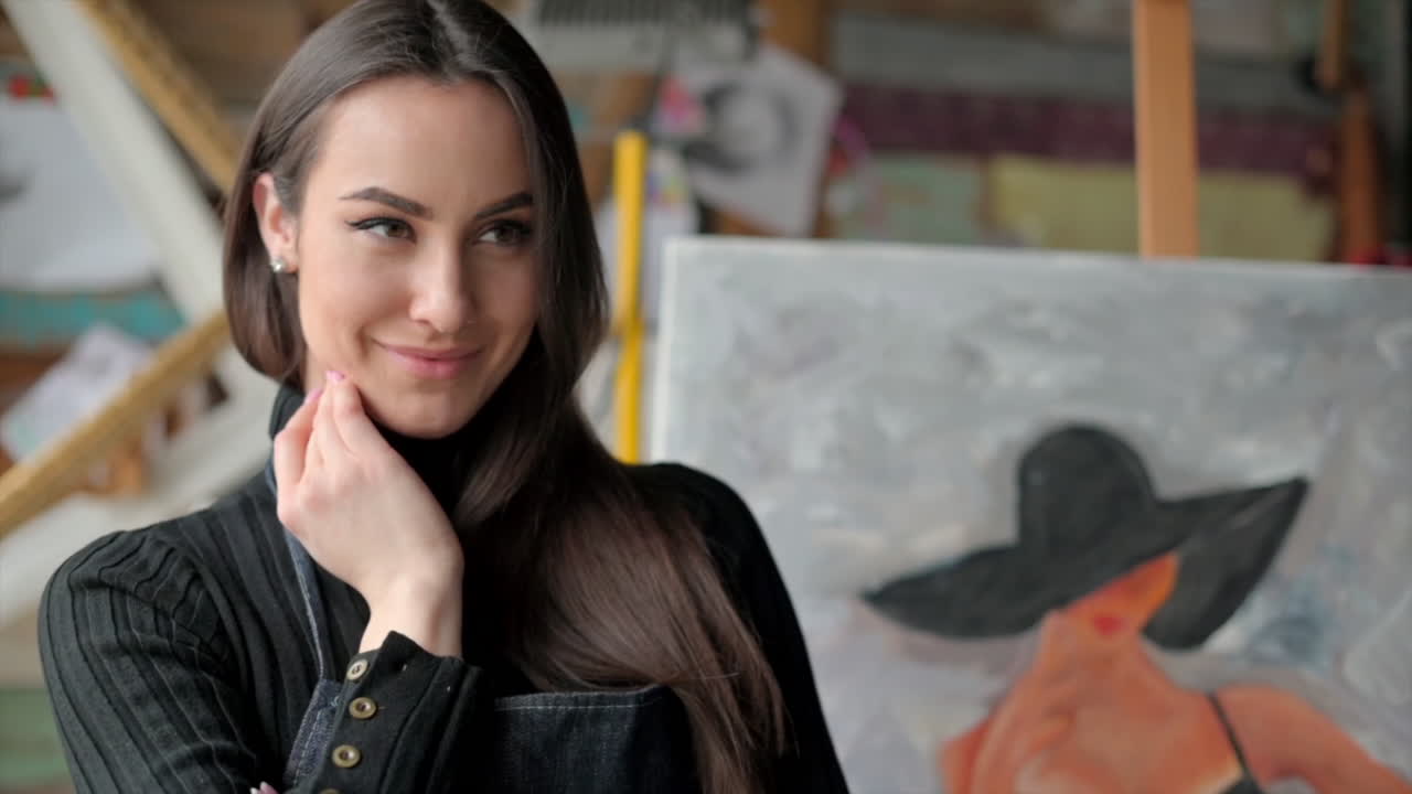 Woman standing in front of a painting at an art gallery workshop