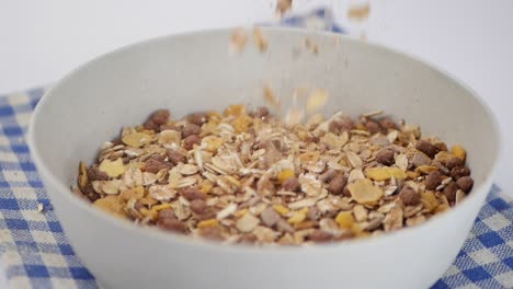 pouring cereal into a bowl