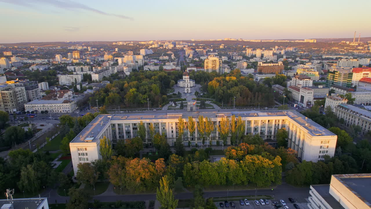 Aerial drone view of Chisinau downtown at sunset, Moldova. View of Central Park, Cathedral, Goverment and a lot of greenery, buildings