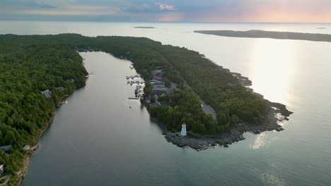 aerial view of a lighthouse on a secluded island at sunset