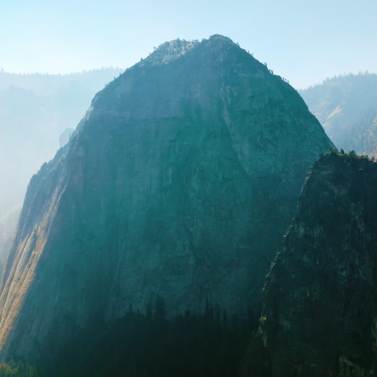 High mountain in the bright light and fog. Gorgeous beautiful rocks of Yosemite National Park, California, USA on hazy morning