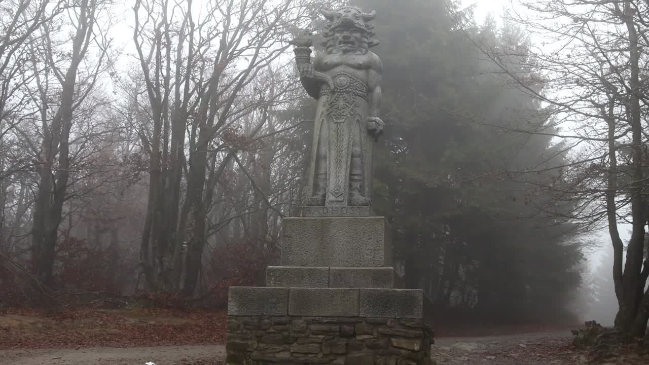 Explore the mystical charm of the "Old Statue of Radegast in the Forest in Czech Republic" footage, showcasing an ancient Slavic god amidst a lush, secluded woodland.