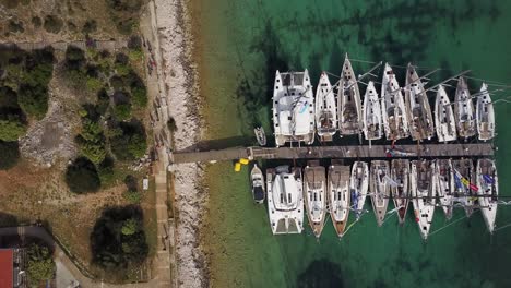 sailboats moored in marine - aerial top down view