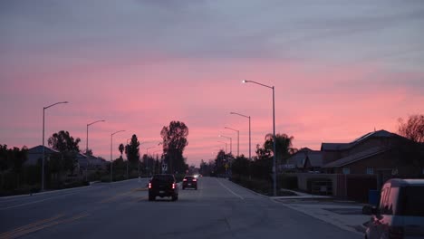 a pastel sky over cars driving away on a road in clovis, ca, usa
