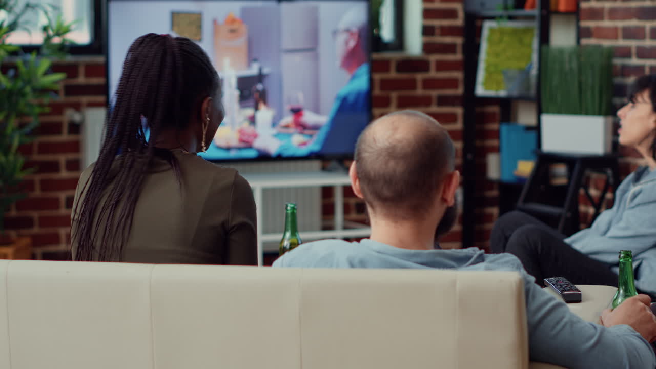 Diverse people enjoying movie on tv channel program