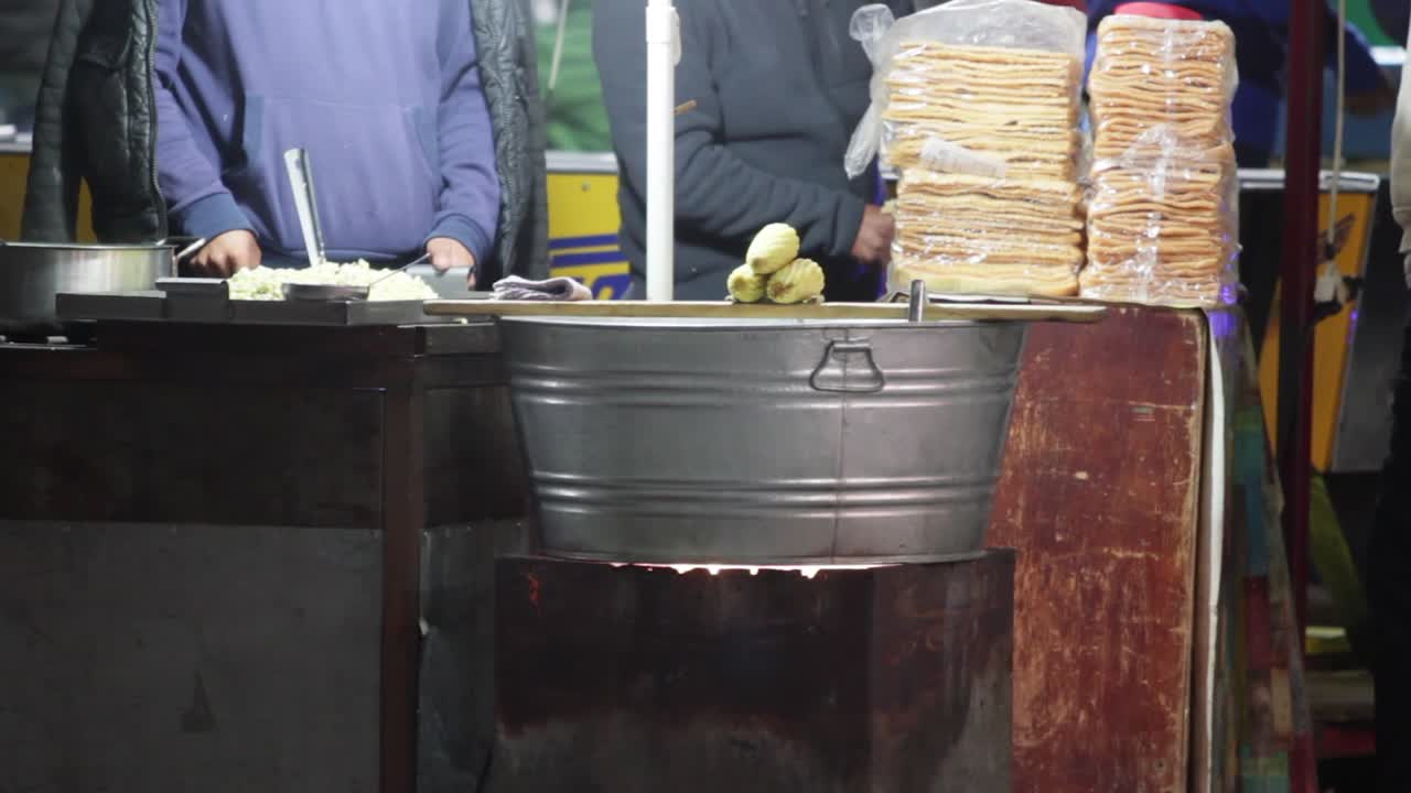 A mexican street vendor selling boil corn