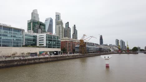 panning view of puerto madero skyscrapers, river and bank of china buildings dockside business center of buenos aires argentina
