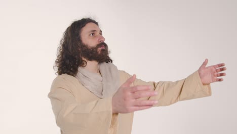 portrait of man wearing robes with long hair and beard representing figure of jesus christ raising hands in prayer 1