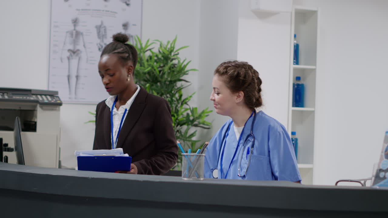 Medical staff at hospital reception assisting patients