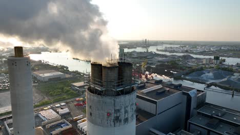 close up view on smoking, steaming, chimney, industrial facility, factory, carbon emission, heavy industry. industrial waste. aerial close up view.