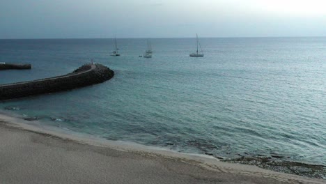 Sailboat Near Beachfront Hotel At Santa Maria In Sal Island, Cabo Verde, Africa. Aerial Pullback Shot
