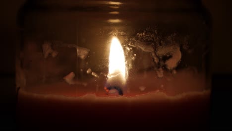 a close up of a moving candle light in a dark room in the night