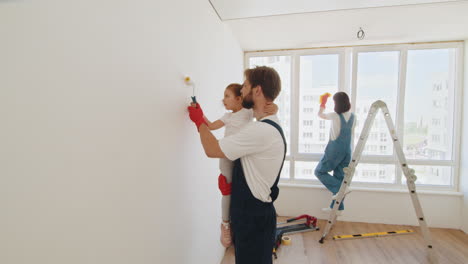 family painting a room together