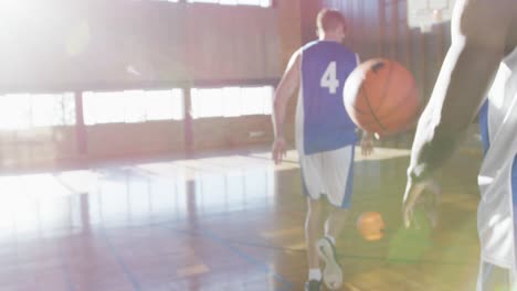 diverse male basketball team and coach practice dribbling ball