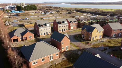 unfinished waterfront townhouse property development construction site aerial view descending