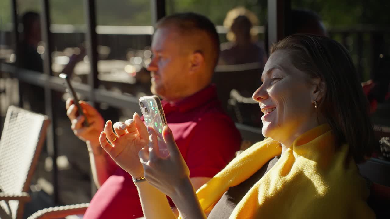Couple Enjoying a Sunny Afternoon at an Outdoor Cafe