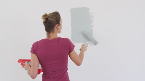 Portrait-of-a-Caucasian-woman-in-quarantine-during-coronavirus-pandemic,-doing-interior-work