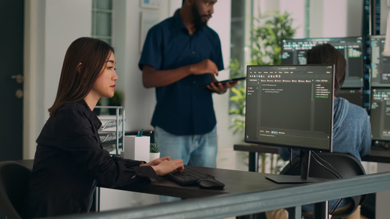 Asian programer typing big data code on computer to work on app developing program