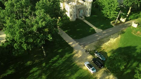 planned aerial shot of unique house castle design top roof , green front yard, chicago