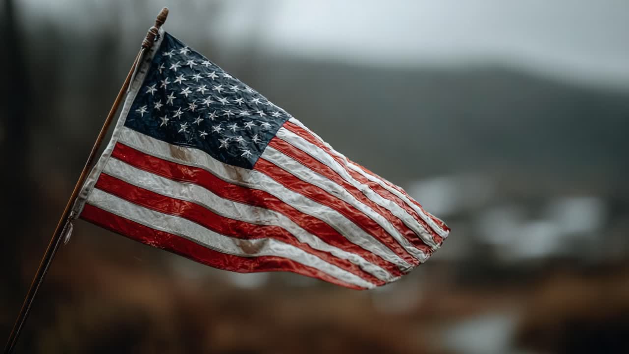 An American Flag Waving in the Wind Amidst a Serene Landscape, Capturing the Spirit of Patriotism and Freedom in a Melancholic Atmosphere