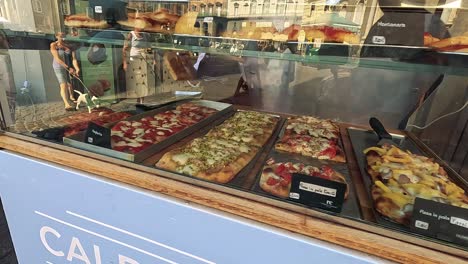 pizza display and street activity in naples