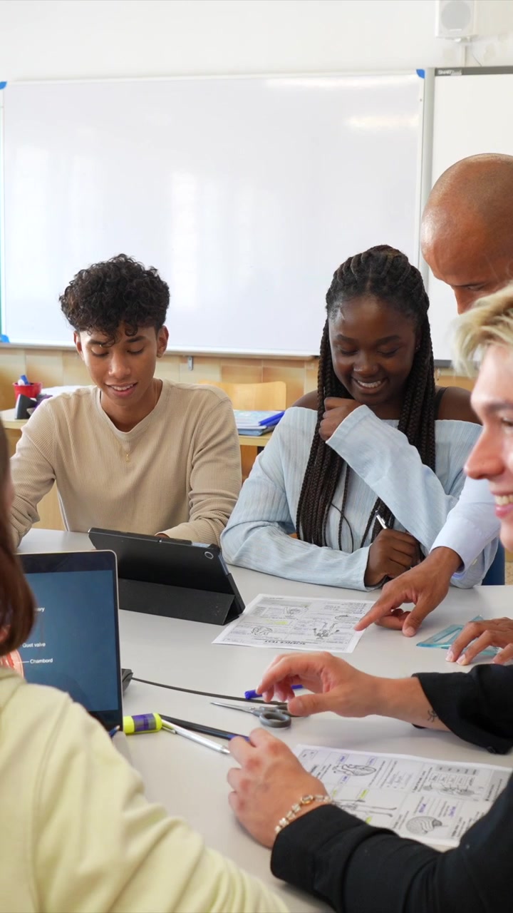Teacher and Students Collaborating on Science Project in Classroom