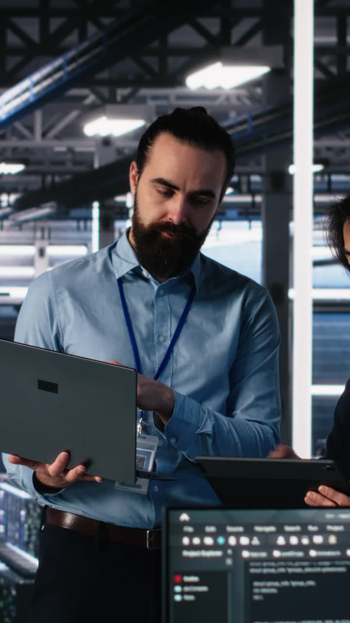 Vertical video Data center manager supervising work done by programmers on neural network