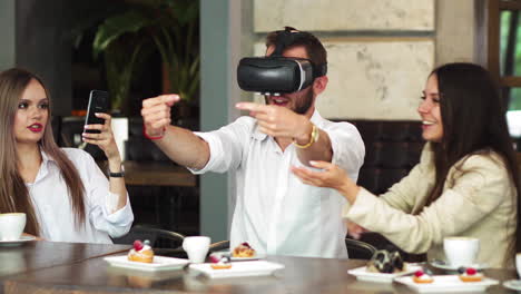 the people with virtual reality headsets on a construction site. the woman shows to group of architects and engineers the project of future interior of the room in the 3d simulator