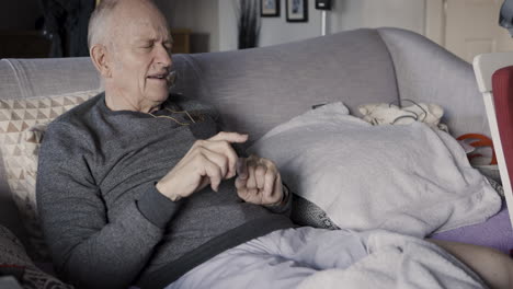 elderly man relaxing on couch