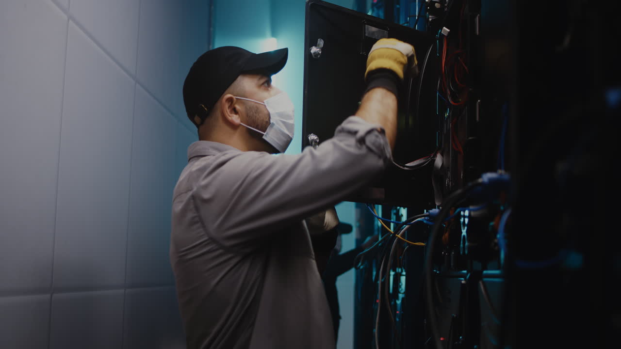 Technician Working on Server Room Equipment