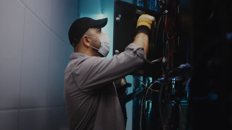 technician working on server room equipment