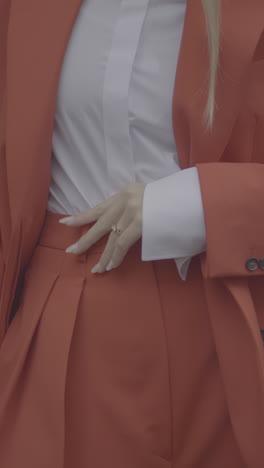 woman in an orange suit and white shirt