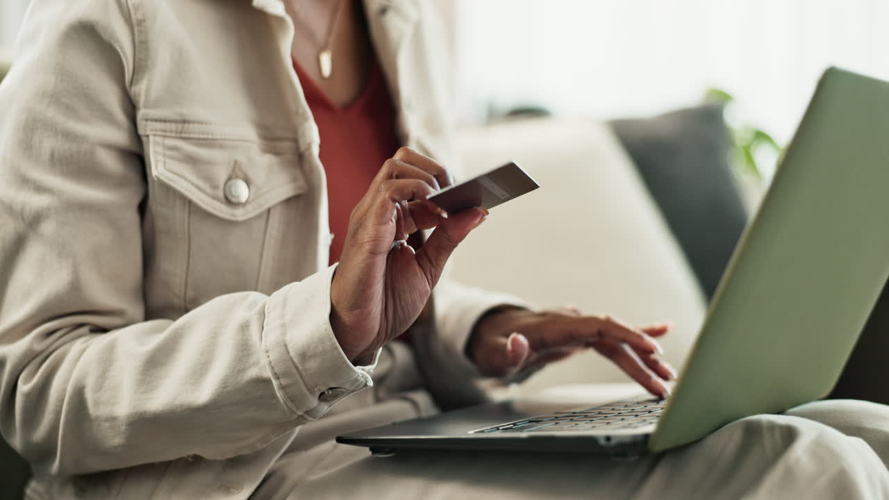 Woman using laptop and credit card for online shopping
