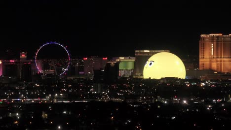 msg sphere arena of the emoji face on the las vegas strip, entertainment of shows, concerts music and casinos, aerial view at night