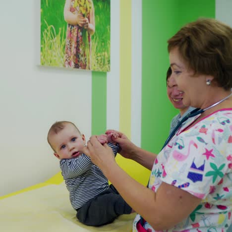 small child seen by pediatrician. caring professional female pediatrician with small child in the clinic