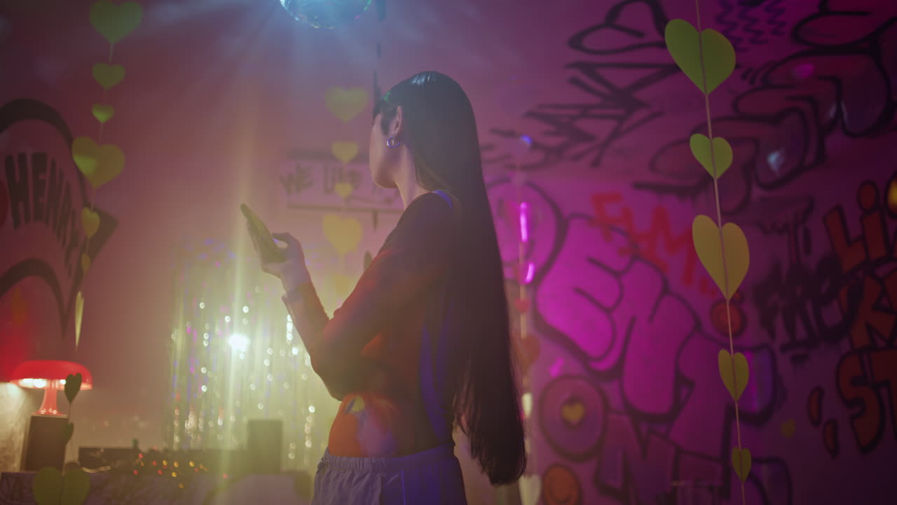 Clubbing girl looking smartphone engaged in club ambiance. female clubber